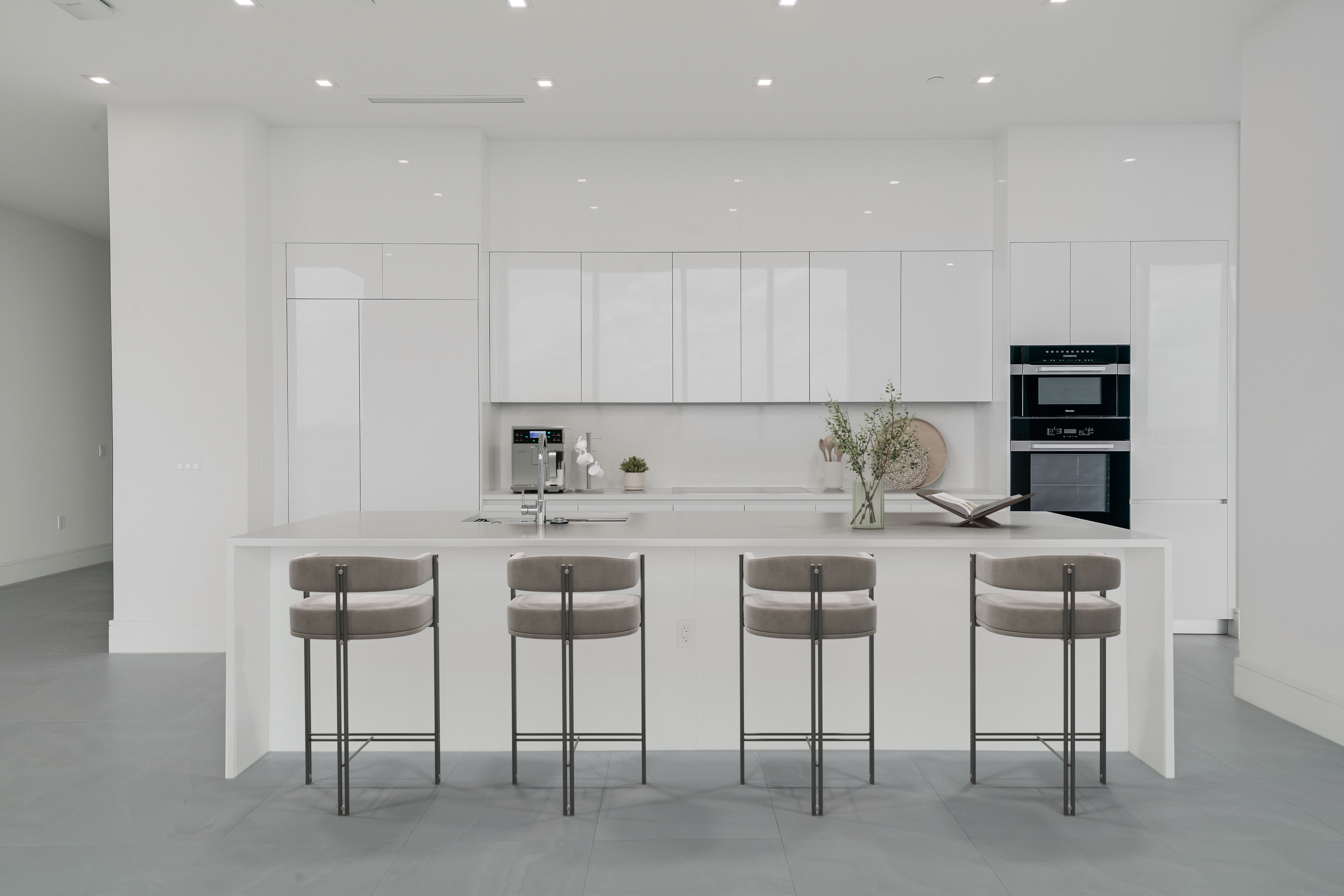Virtually staged white kitchen with oversized island in Residence 612