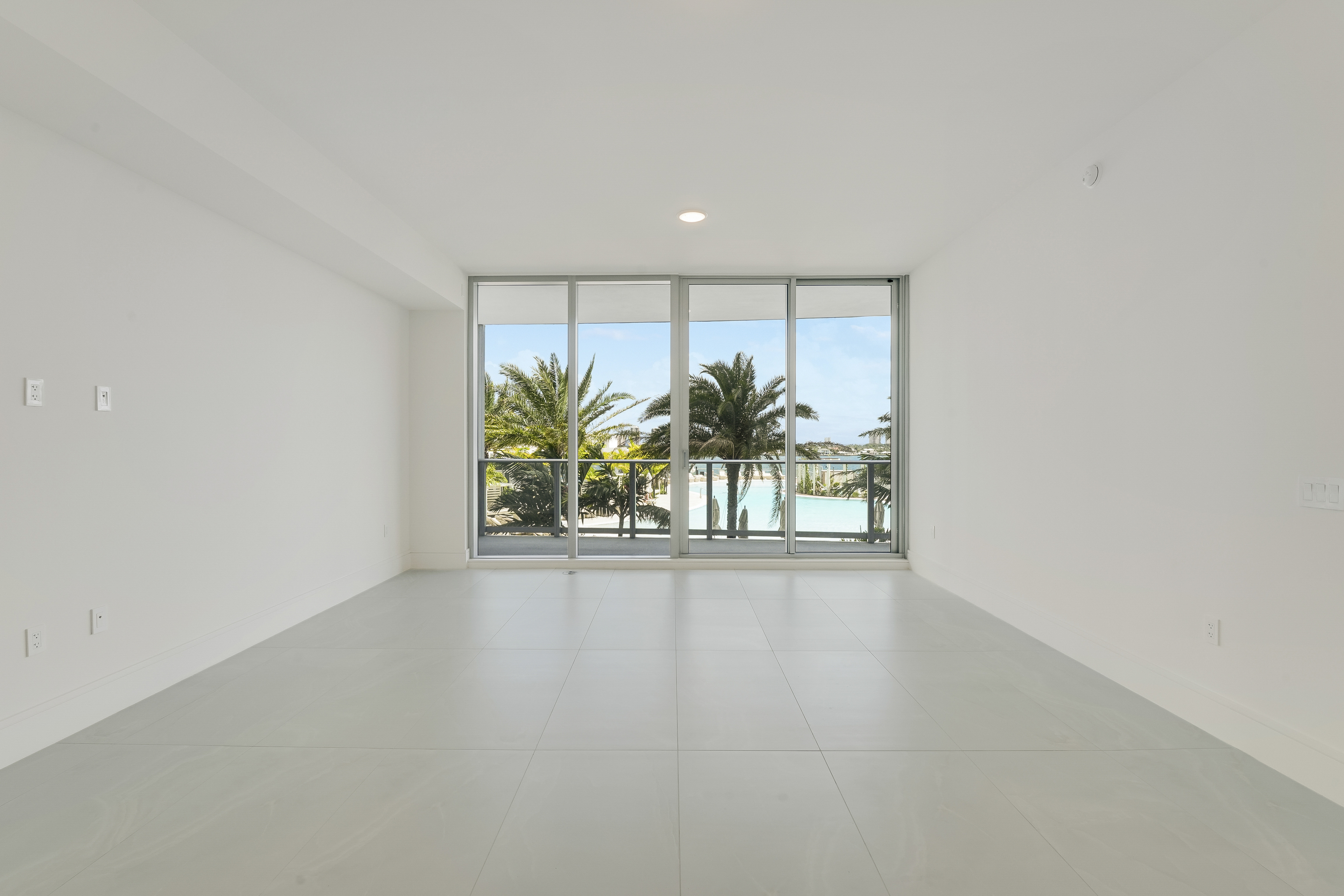 Water-facing living space in Executive 704 with floor-to-ceiling glass